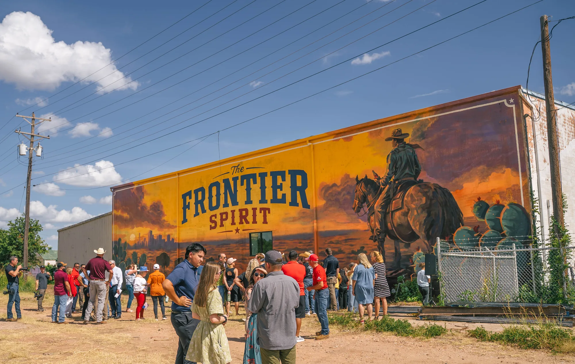 Crowd at the unveiling of the Frontier Spirit Coca-Cola mural in Abilene, Texas