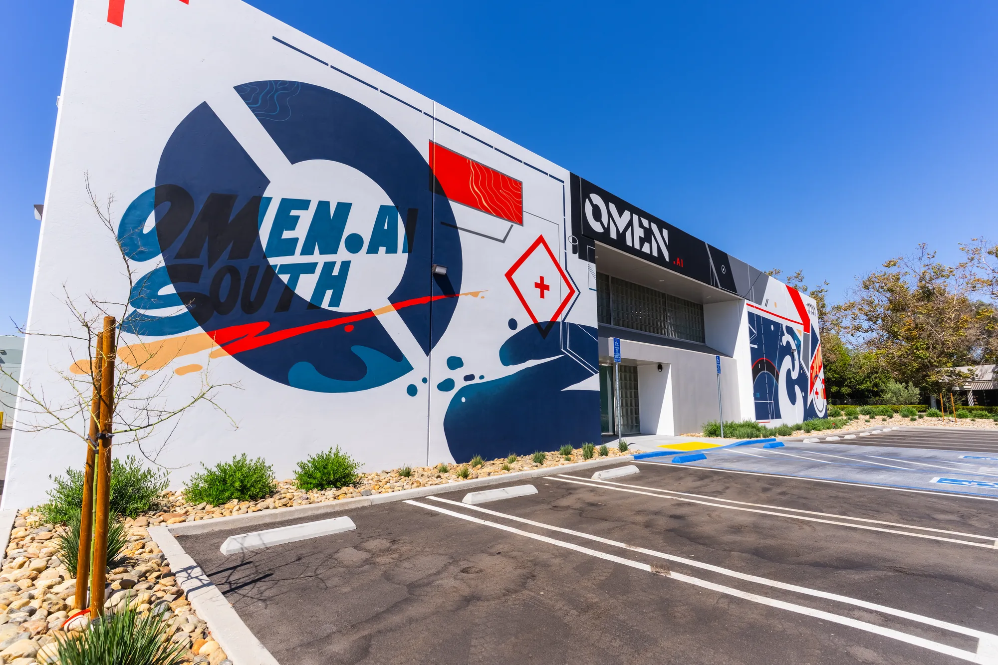 Omen AI headquarters building painted with a large exterior supergraphic mural